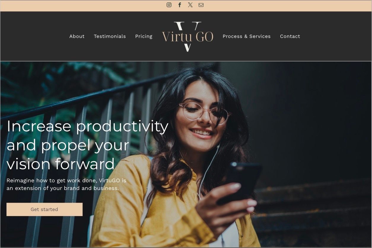 A woman is smiling while looking at her cell phone.