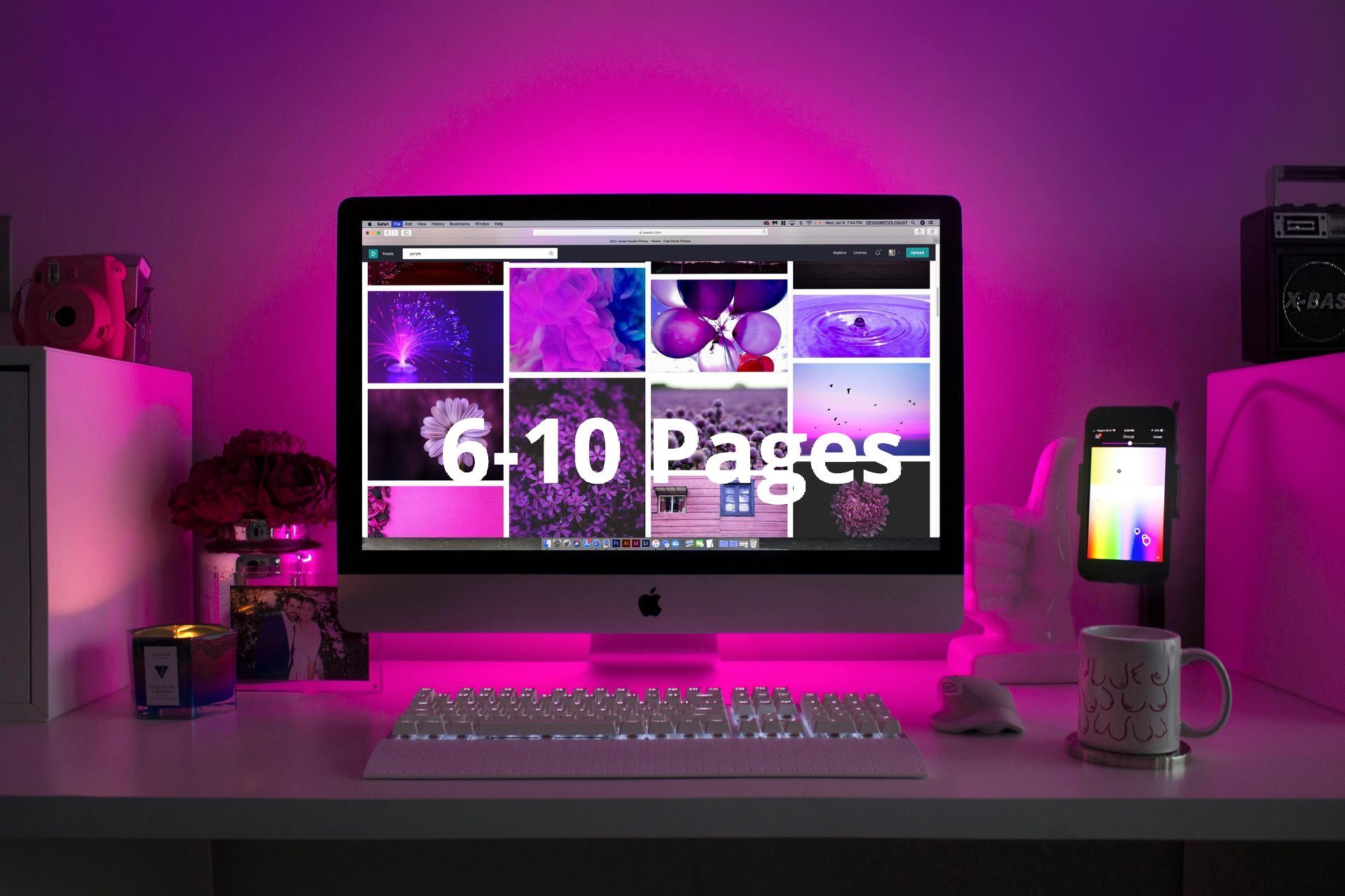 A computer monitor is sitting on a desk with purple lights behind it.