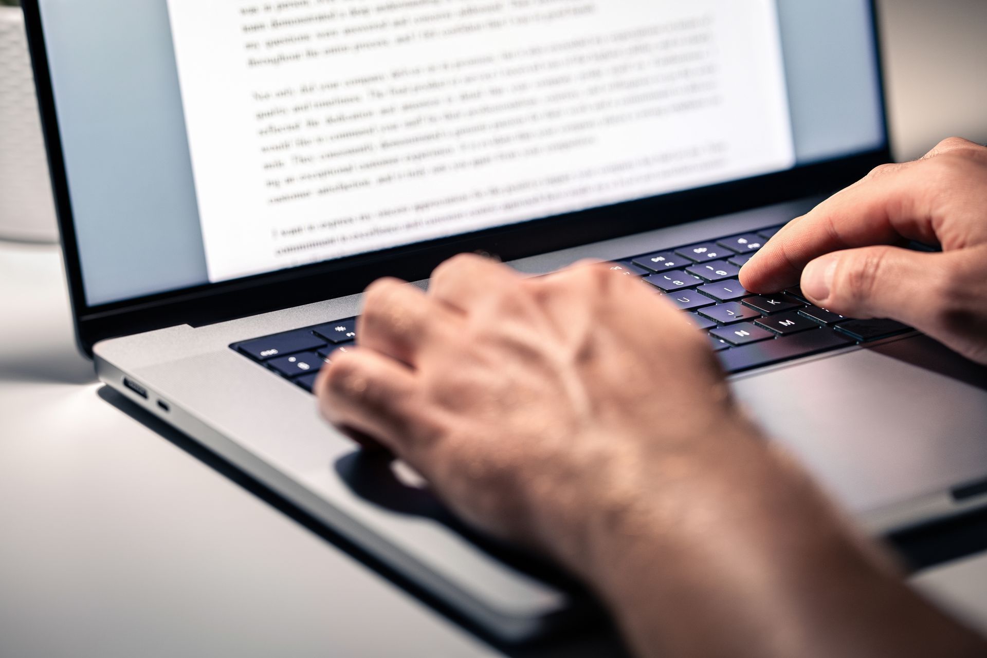 A person is typing on a laptop computer.