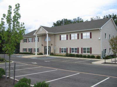 A large building with a parking lot in front of it