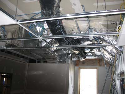 A room with a lot of pipes coming out of the ceiling.