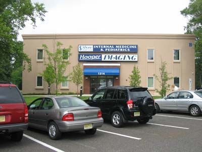 Several cars are parked in front of a building that says haeger imaging