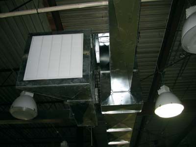 There are a lot of lights hanging from the ceiling of a building.