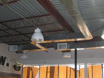 A ceiling with a lot of ducts hanging from it