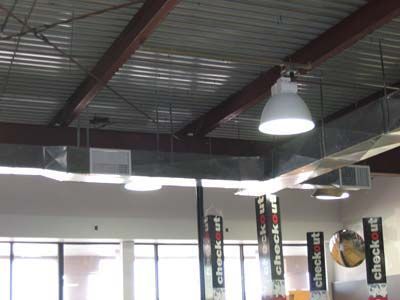 A check out sign hangs from the ceiling of a building