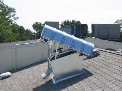 A large metal object is sitting on top of a roof.