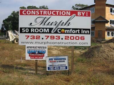 A sign that says construction by murph 50 room comfort inn