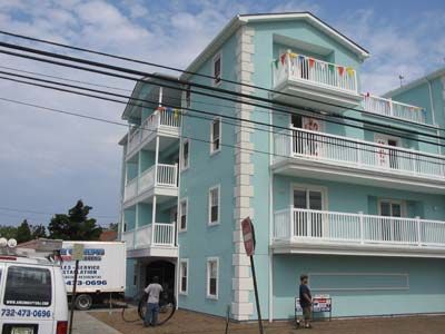 A blue building with a white van parked in front of it