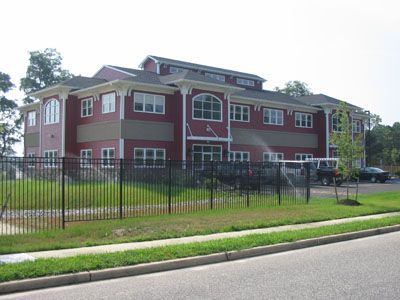 A large red building with a fence in front of it