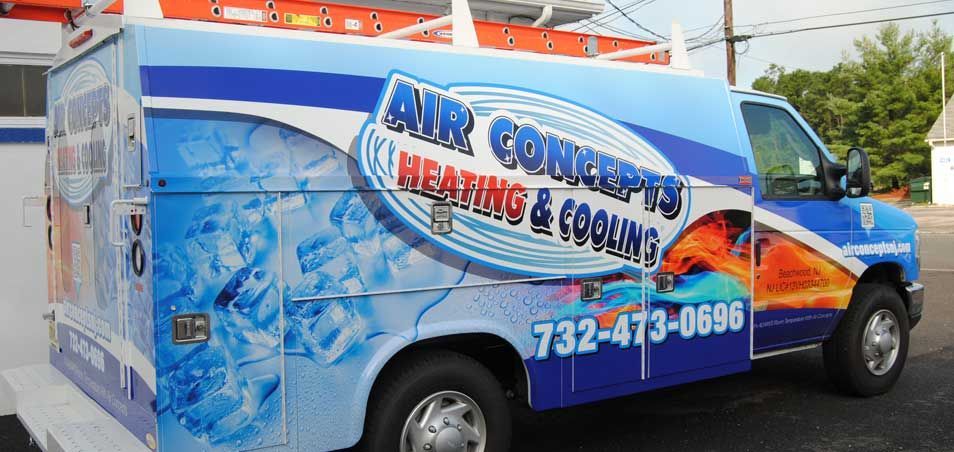 A blue and white air concepts van is parked on the side of the road