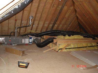 An attic with a lot of pipes coming out of it