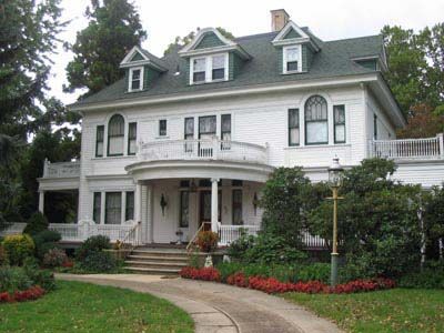 A large white house with a driveway leading to it