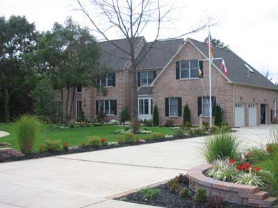 A large brick house with a flag in front of it