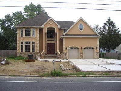 A large house with a concrete driveway in front of it