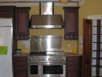 A kitchen with stainless steel appliances and wooden cabinets