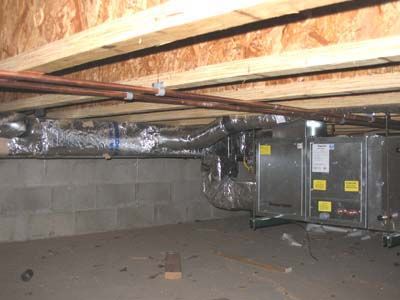 A basement with a heating and air conditioning system in it.