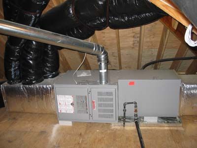 An air conditioner is installed in the attic of a house.