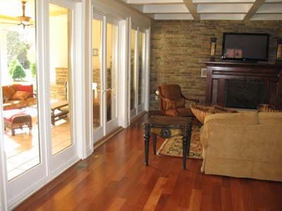 A living room with hardwood floors and a fireplace.