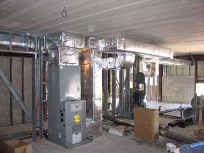 A room with a heater and air ducts in it.