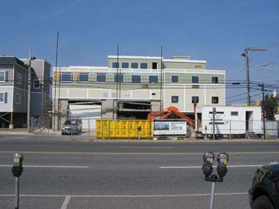 A large building is being built on the side of the road