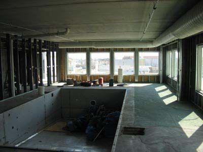 A large room with a swimming pool in the middle of it.