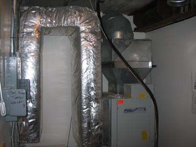 A room with a duct and a heater in it.