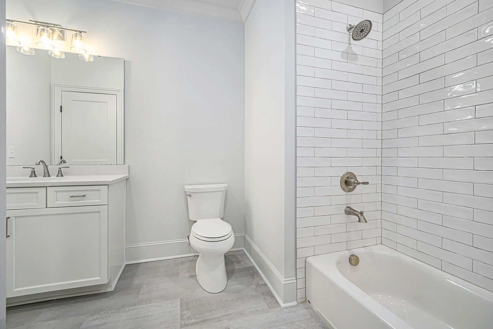 A bathroom with a toilet , sink , shower and bathtub.