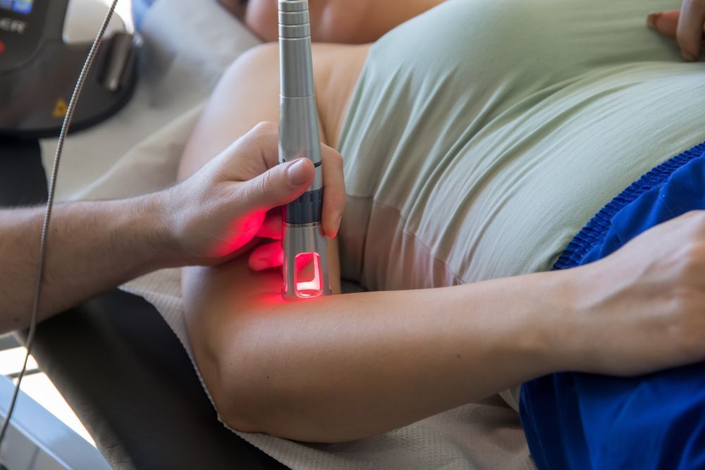 A person is getting a laser treatment on their arm.