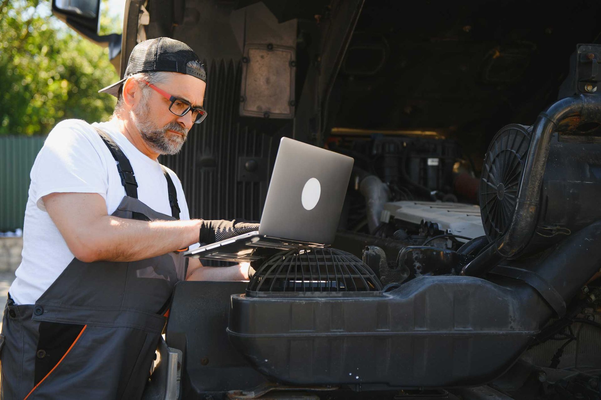 A mechanic makes a computer diagnostic of the semitruck.