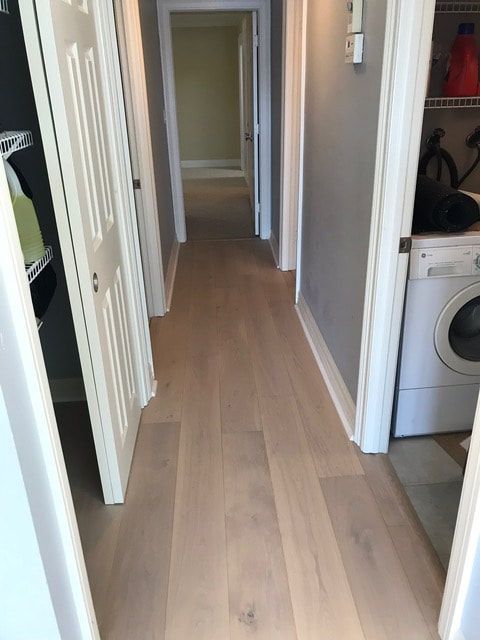 A hallway in a house with a washer and dryer