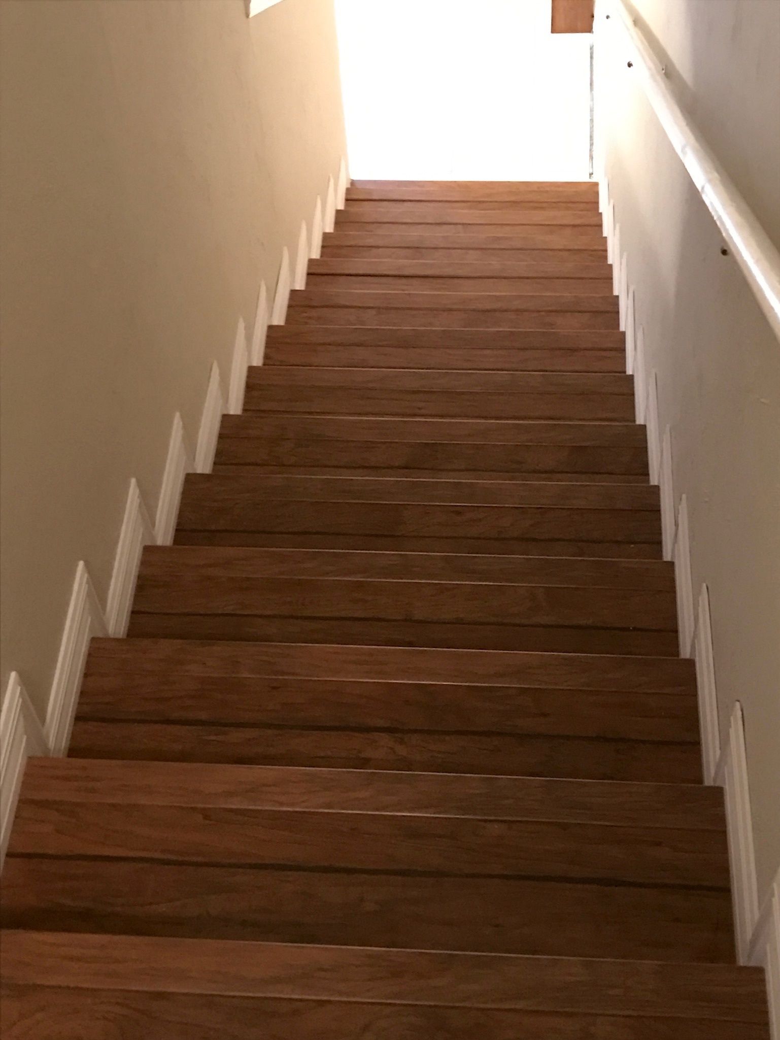 A set of wooden stairs leading up to a doorway.