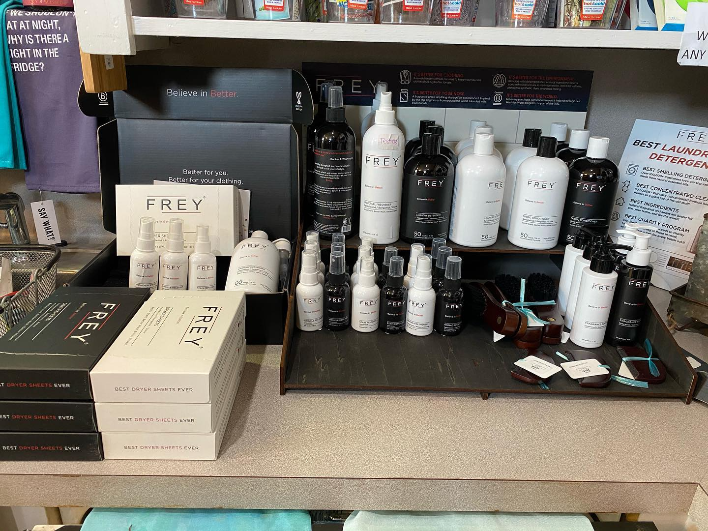 Salon product display with white bottles and boxes on a counter under a shelf