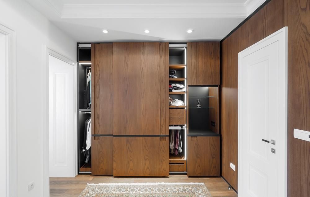 A Walk In Closet With Sliding Doors And Wooden Cabinets — North Coast Cabinetmaking Pty Ltd In Whitsundays, QLD