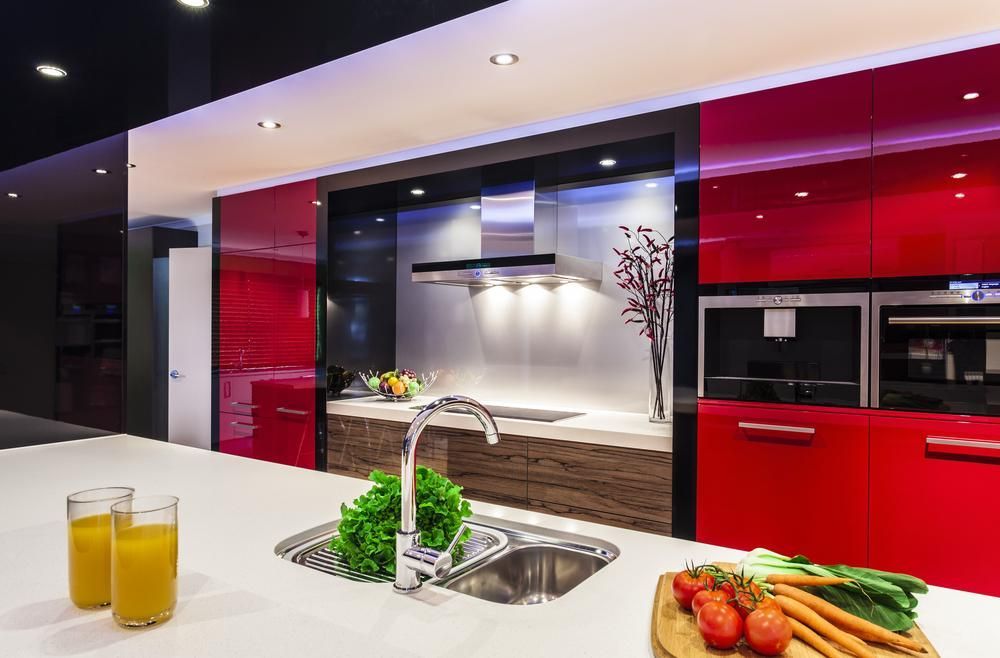 A Kitchen With Red Cabinets And Vegetables On The Counter — North Coast Cabinetmaking Pty Ltd In Cannonvale, QLD
