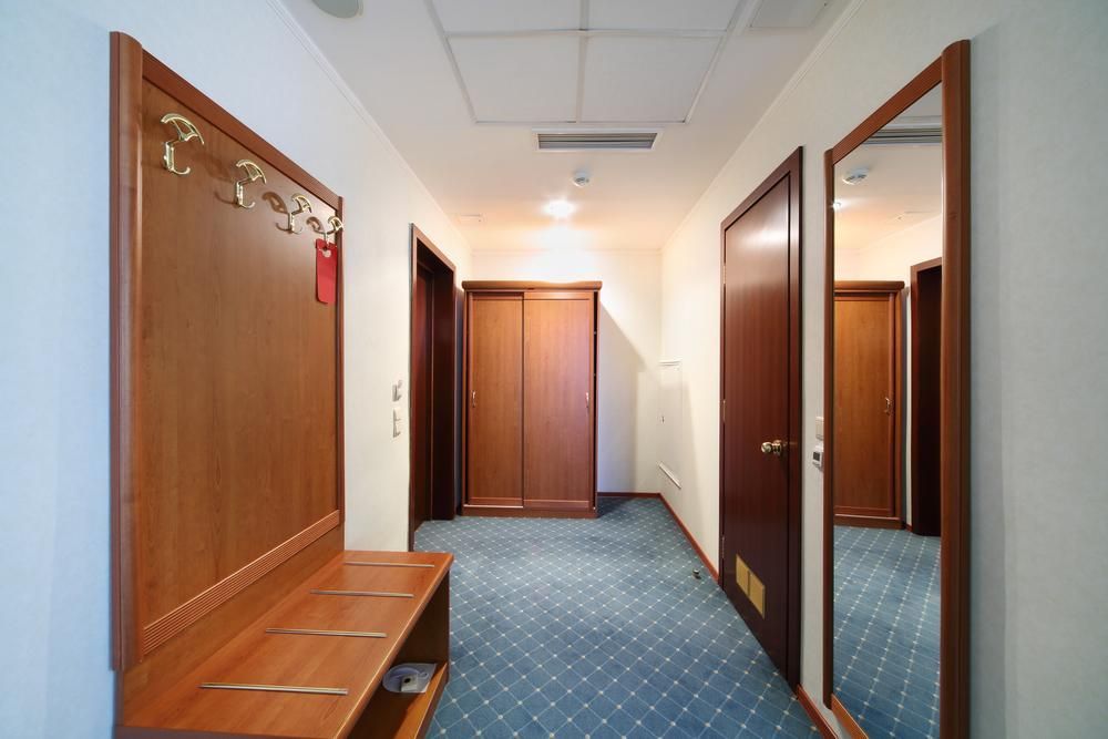 A Hotel Hallway With A Bench And A Mirror — North Coast Cabinetmaking Pty Ltd In Proserpine, QLD