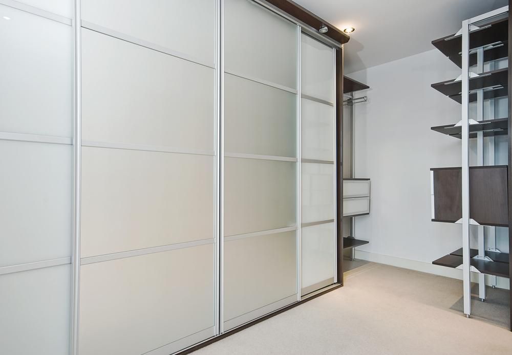 A Walk In Closet With Sliding Glass Doors And Shelves — North Coast Cabinetmaking Pty Ltd In Proserpine, QLD