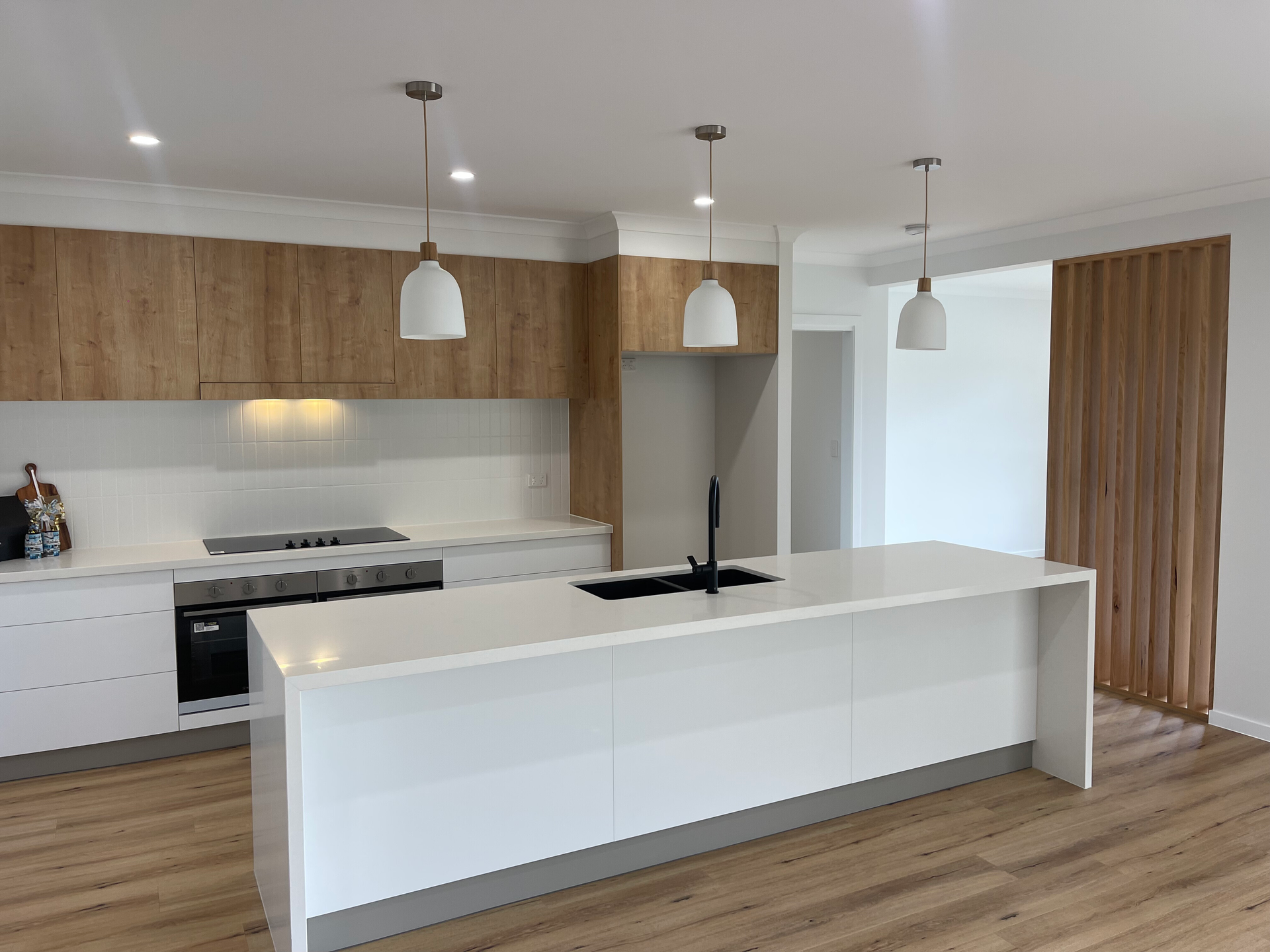 A Kitchen With A Sink, Stove, And Downlights — North Coast Cabinetmaking Pty Ltd In Proserpine, QLD