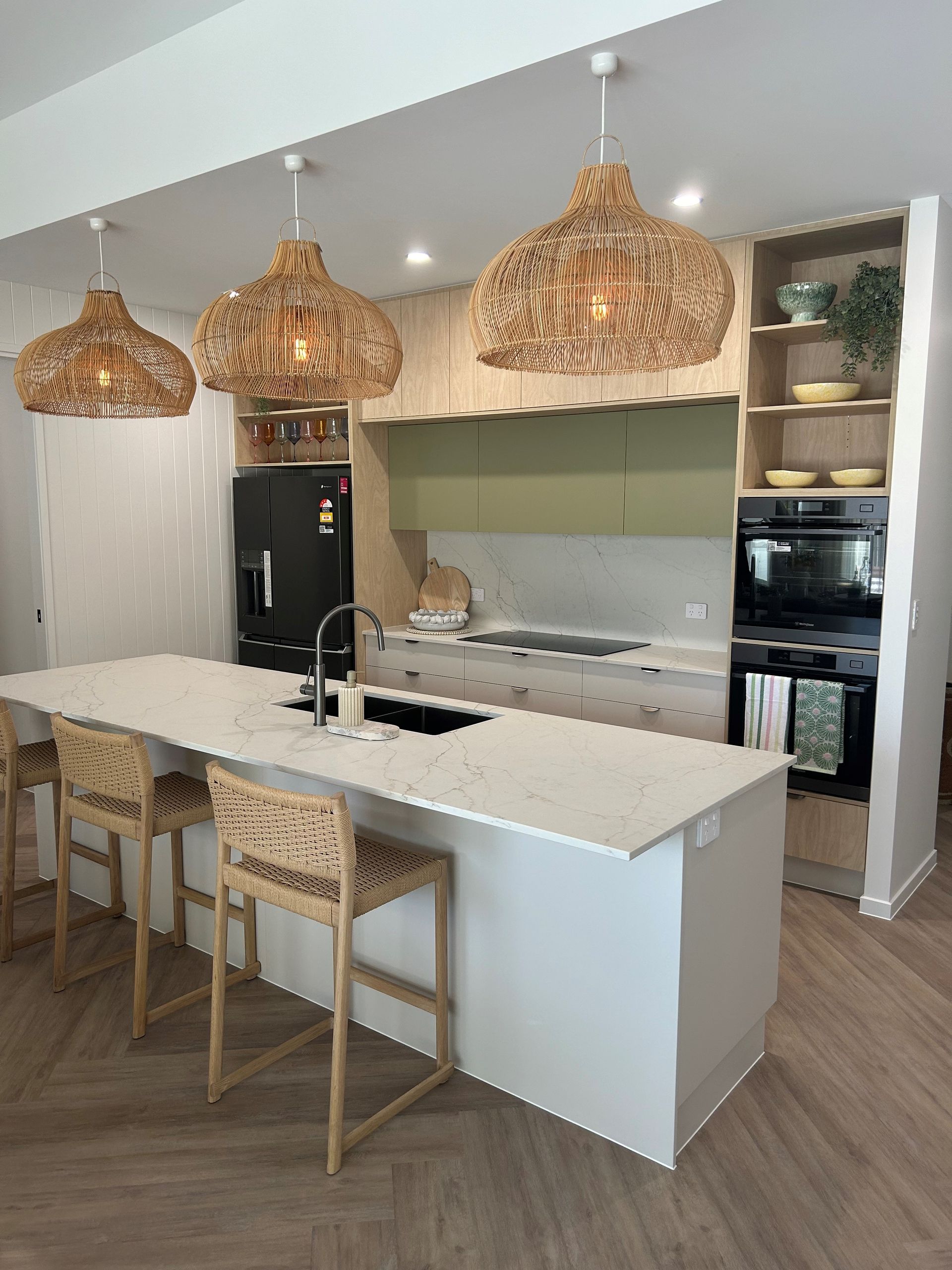 An Empty Kitchen With A Large Island And A Sink — North Coast Cabinetmaking Pty Ltd In Proserpine, QLD