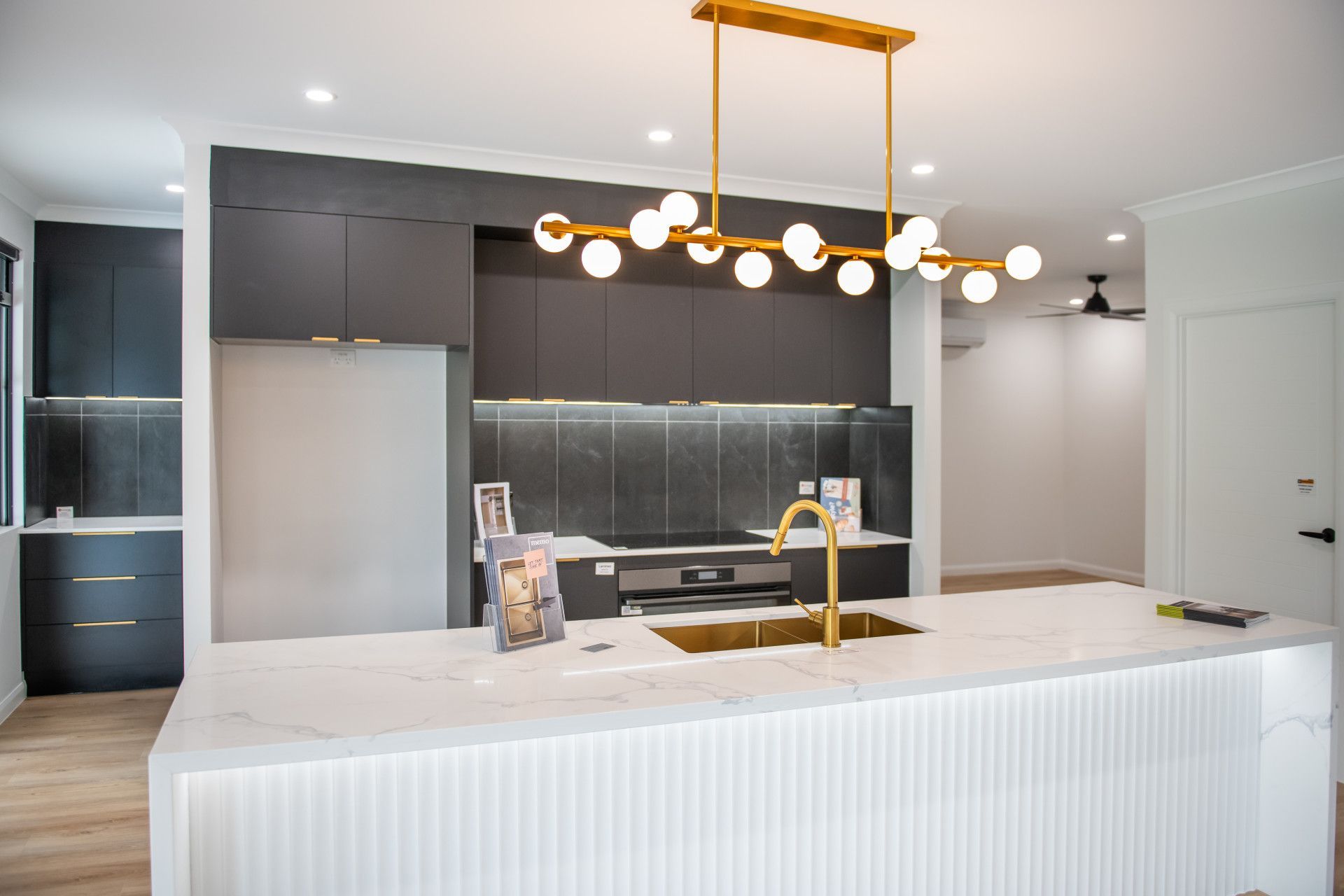 A Kitchen With White Cabinets And A Gold Sink — North Coast Cabinetmaking Pty Ltd In Proserpine, QLD