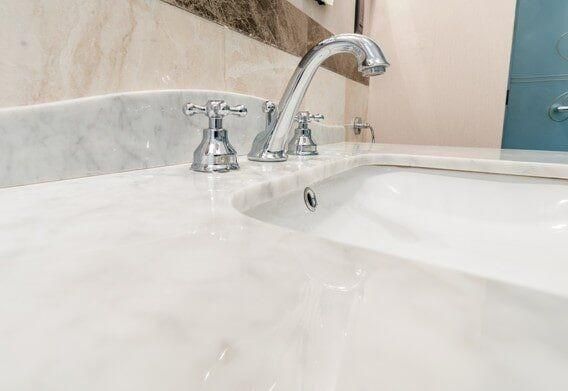 A Bathroom Sink With A Faucet And A Mirror — North Coast Cabinetmaking Pty Ltd In Cannonvale, QLD