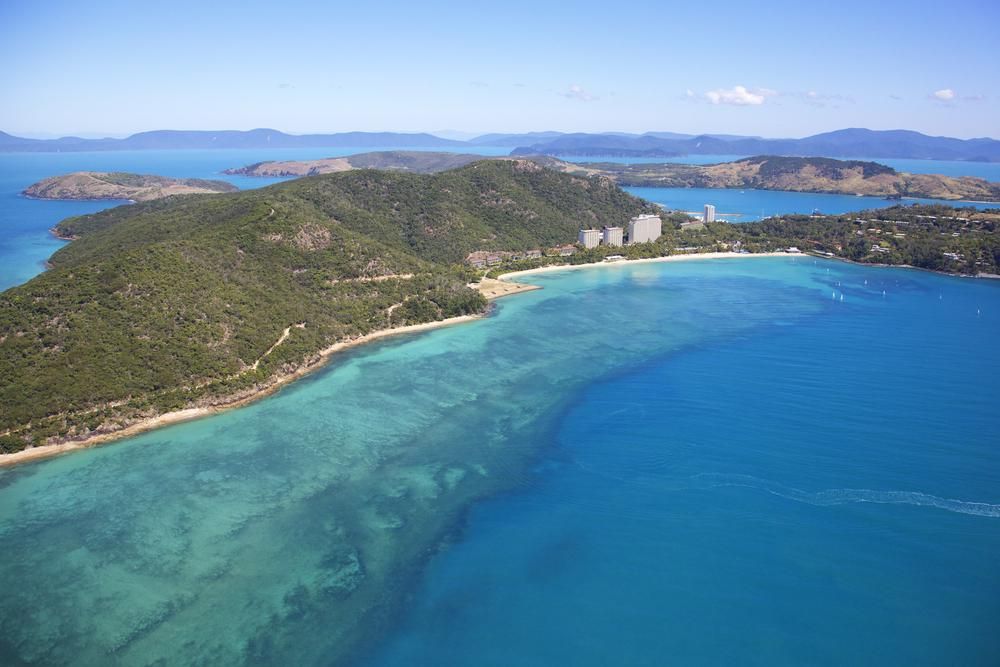 A Large Body Of Water With Mountains In The Background — North Coast Cabinetmaking Pty Ltd In Whitsundays, QLD