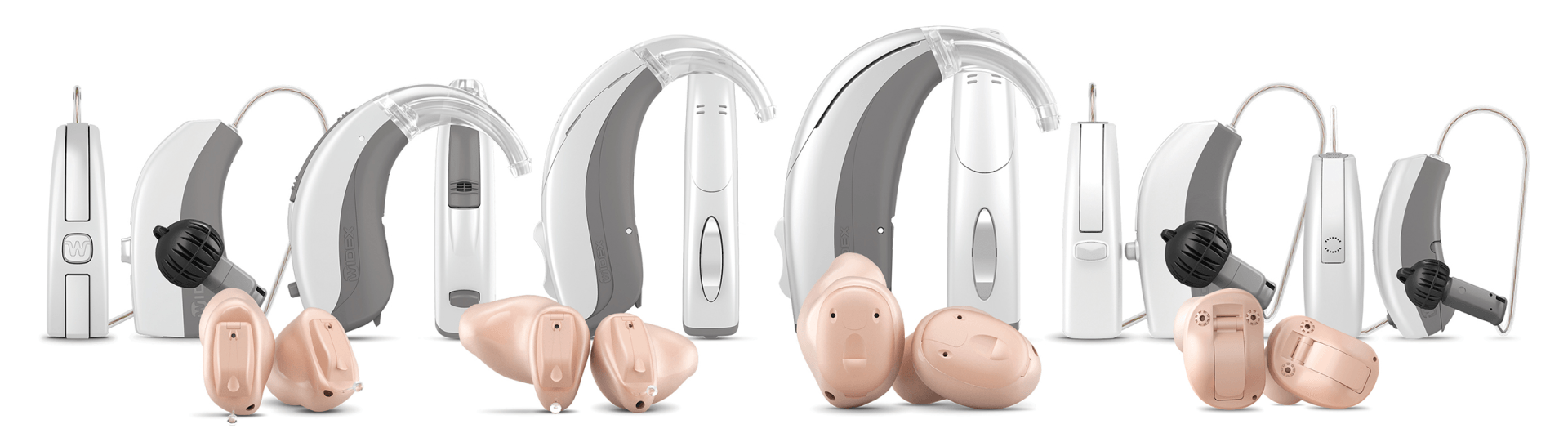 A group of hearing aids are lined up in a row on a white background.
