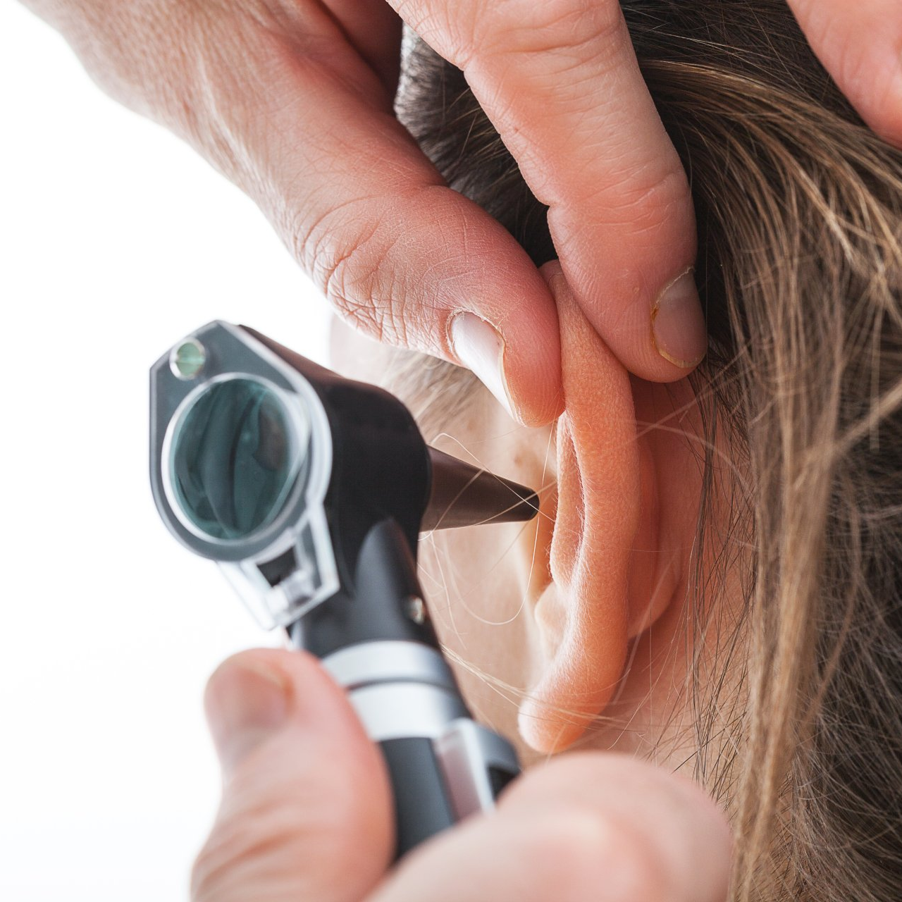 using otoscope to check lady's ear