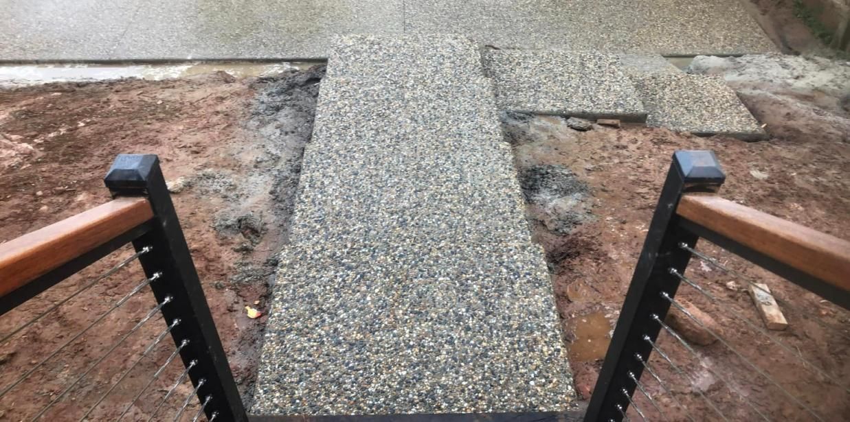 A Concrete Walkway With A Wooden Railing Is Being Built — Value Concreting In Gordonvale, QLD