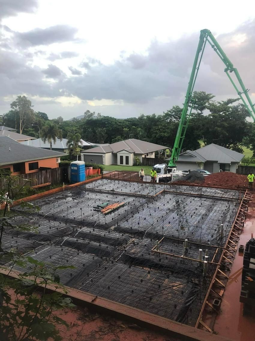 A Concrete Pump Is Being Used To Pour Concrete On A Construction Site — Value Concreting In Gordonvale, QLD