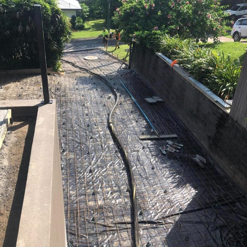A Hose Is Laying On The Ground Next To A Wall — Value Concreting In Gordonvale, QLD