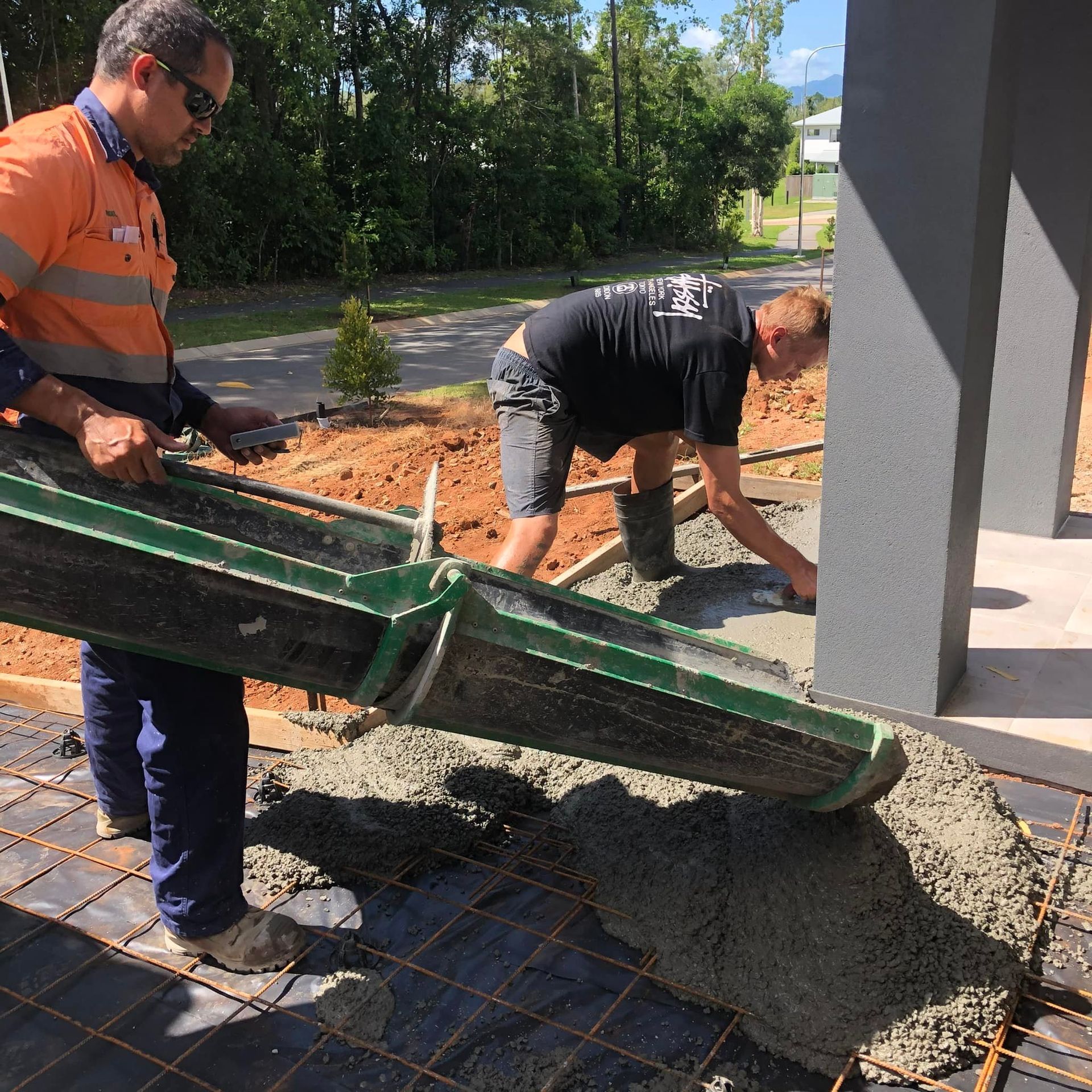 Two Workers Pouring Concrete — Value Concreting In Innisfail, QLD