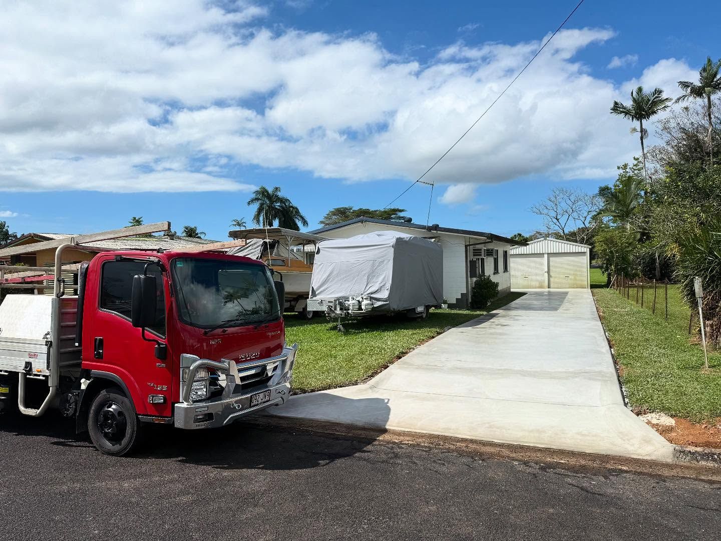 Red Flatbed Truck Parked on Road — Value Concreting In Innisfail, QLD