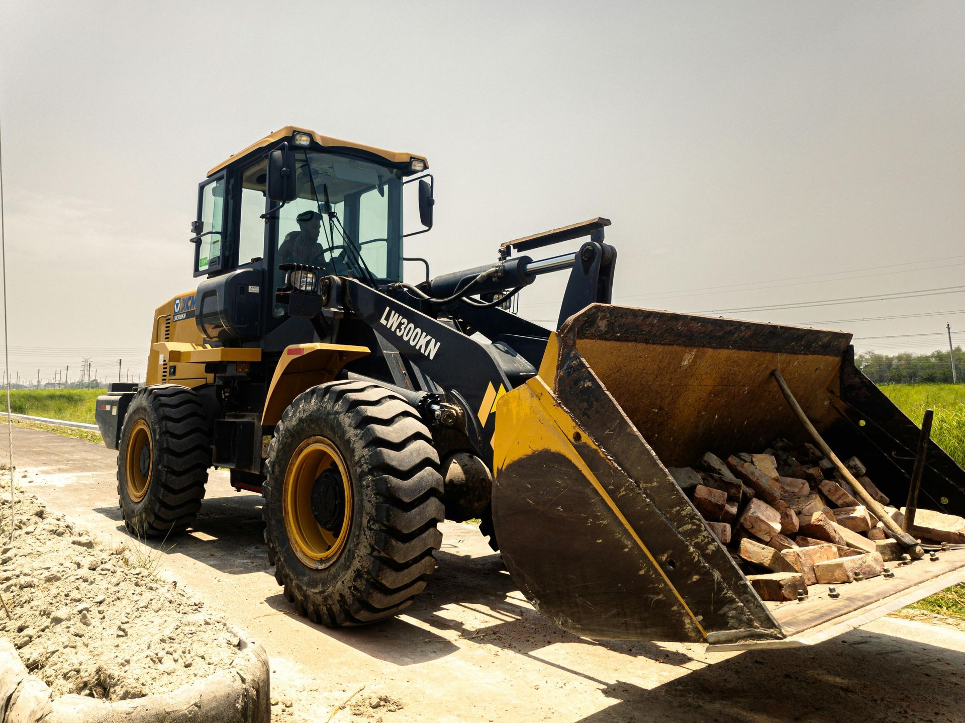A bulldozer is sitting on the side of a road.