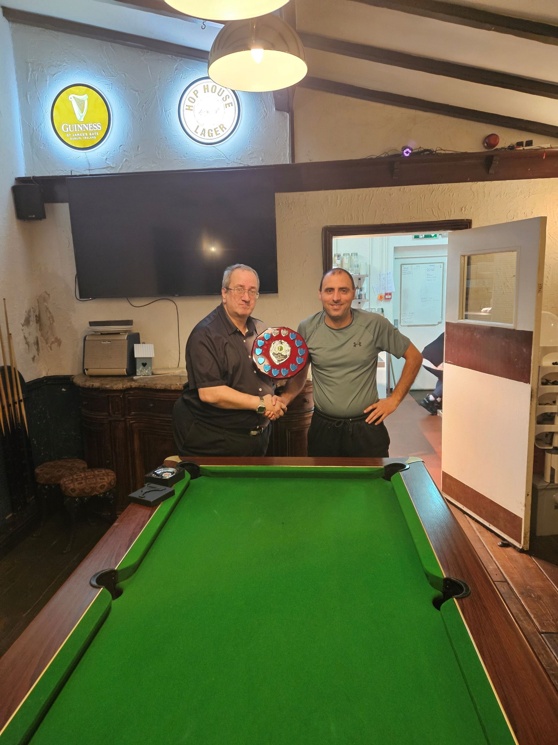 Conquering Heroes’ Team Captain John Dellafera (left) presents the Geoff Gatt Memorial Trophy for the team’s Most Valuable Player in the 2024 season to Kevin Dempsey (right) who won it in his first season with the team.